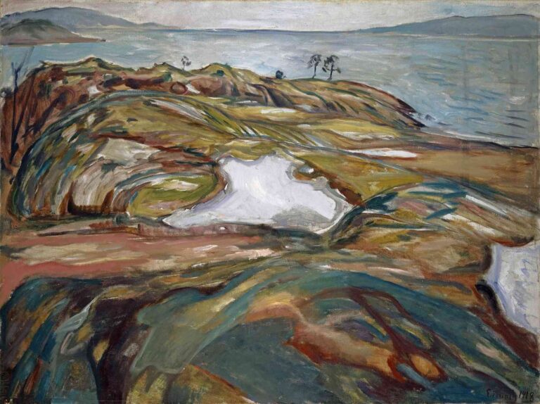 Edvard Munch’s Coastal Landscape (1918) shows a rugged Norwegian shoreline with sweeping, multicolored bedrock in the foreground, pale fjord waters under a cloudy sky, and distant hills on the horizon.