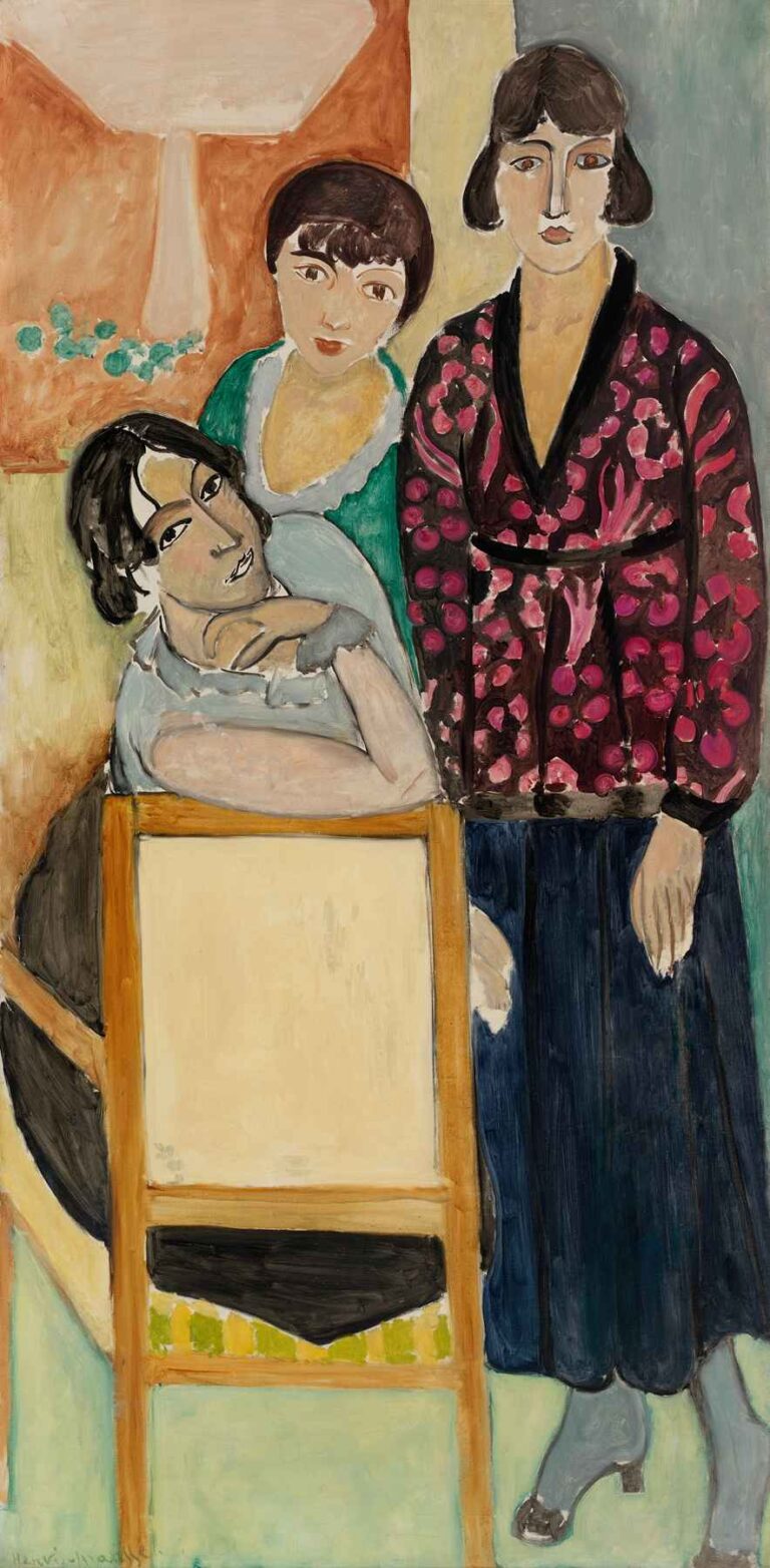 Three Sisters and “The Rose Marble Table” by Henri Matisse (1917): three young women—one seated leaning on a pink‐veined marble table, another in green behind her, and a third in a dark jacket with magenta blossoms—stand before vertical apricot, pale yellow, and slate‐gray bands.