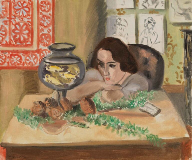 Young Woman before an Aquarium by Henri Matisse (c. 1922): a seated woman rests her chin on folded arms atop a pink tablecloth scattered with green foliage, gazing into a small glass aquarium with goldfish, against a backdrop of red stencil pattern, pinned sketches, and wallpaper.