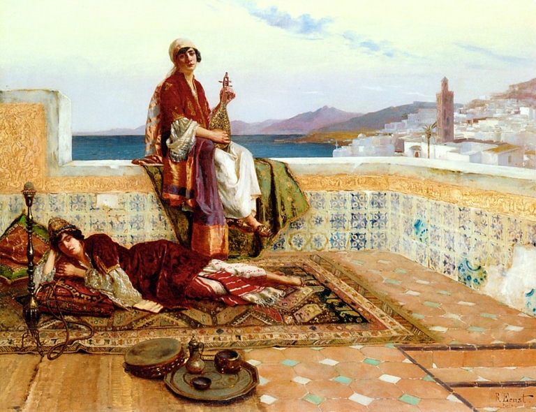 Painting "Young Ladies on a Terrace in Tangiers" by Rudolf Ernst, depicting two women in luxurious North African attire relaxing on a tiled terrace overlooking the sea and the city of Tangiers. One woman sits holding a hookah while the other reclines on richly patterned carpets. The scene features detailed Islamic tilework, brass trays, and a panoramic view of whitewashed buildings, a minaret, and distant mountains under a bright sky.
