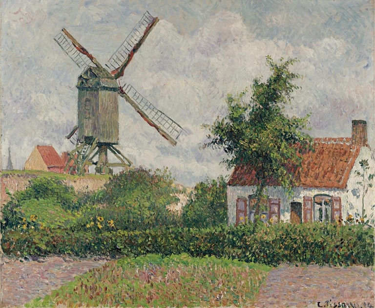 Painting "The Kalfmolen in Knokke" by Camille Pissarro. A peaceful rural scene with a large wooden windmill standing on the left under a softly clouded sky, its angled blades stretching across the canvas. On the right, a small white cottage with a red-tiled roof sits behind a green hedge and flowering garden, framed by a slender tree. The landscape shimmers with textured, colorful brushstrokes capturing light and atmosphere.