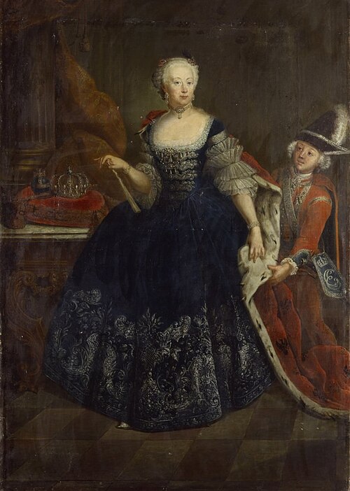 Painting "Elisabeth Christine of Brunswick-Bevern, Queen of Prussia" by Antoine Pesne. The queen stands in a richly embroidered dark gown with an ermine-trimmed mantle held by an attendant. A crown rests on a red cushion behind her, while her composed expression and regal posture reflect her royal status. The scene is set against a grand, subdued architectural backdrop.