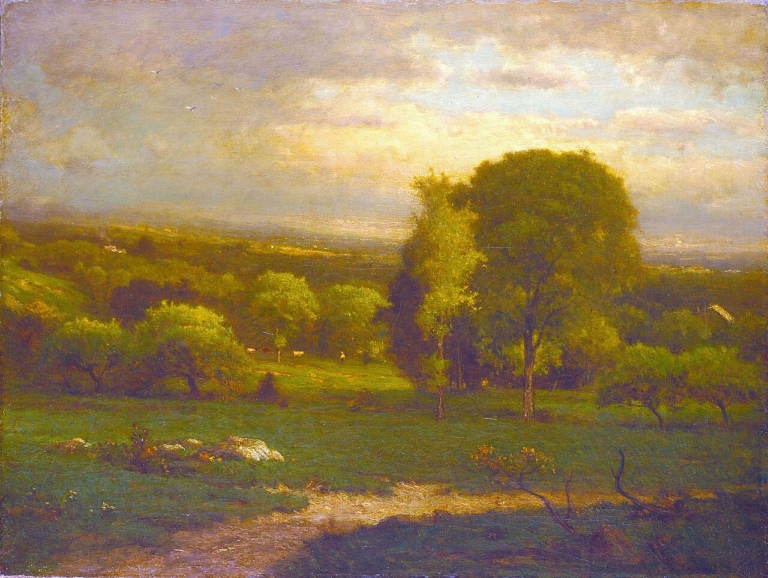 Painting "Saco Valley" by George Inness. A tranquil landscape with soft, glowing light illuminating rolling green fields, clusters of trees, and distant hills under a cloudy, pastel-toned sky. A large tree stands prominently in the foreground while the hazy atmosphere blends earth and sky into a unified, peaceful scene.