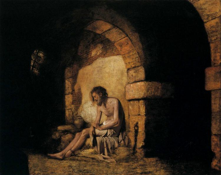 Painting "The Captive from Sterne" (1774) by Joseph Wright of Derby. A shirtless man sits slumped against a stone wall inside a dim prison cell, illuminated by a shaft of light. His expression and posture reflect despair and loneliness, with sparse surroundings including a chain, a jug, and rough stone architecture emphasizing his isolation.
