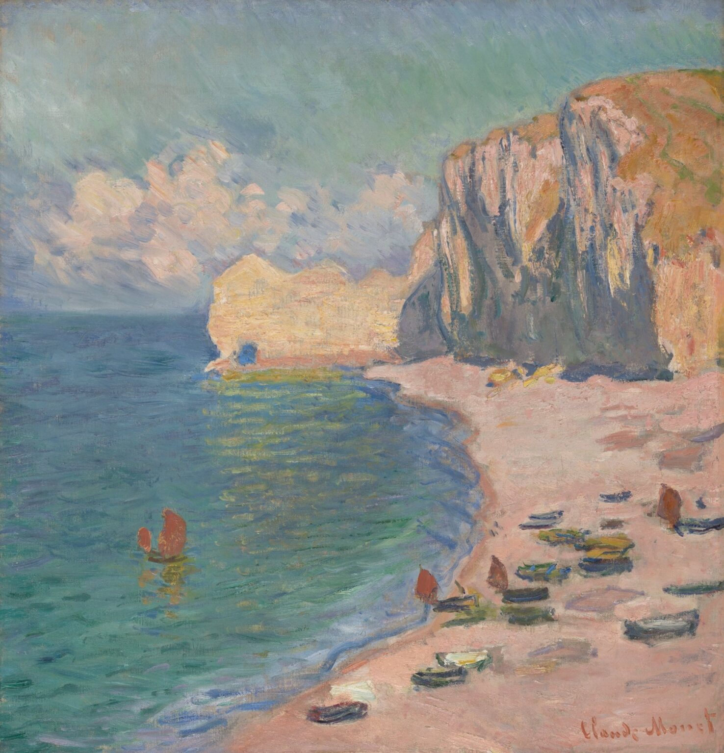 A sunlit Normandy beach strewn with pebbles leading to a towering chalk cliff on the right, under a blue sky with fluffy clouds, with small sailboats dotting the green-blue sea in the distance.
