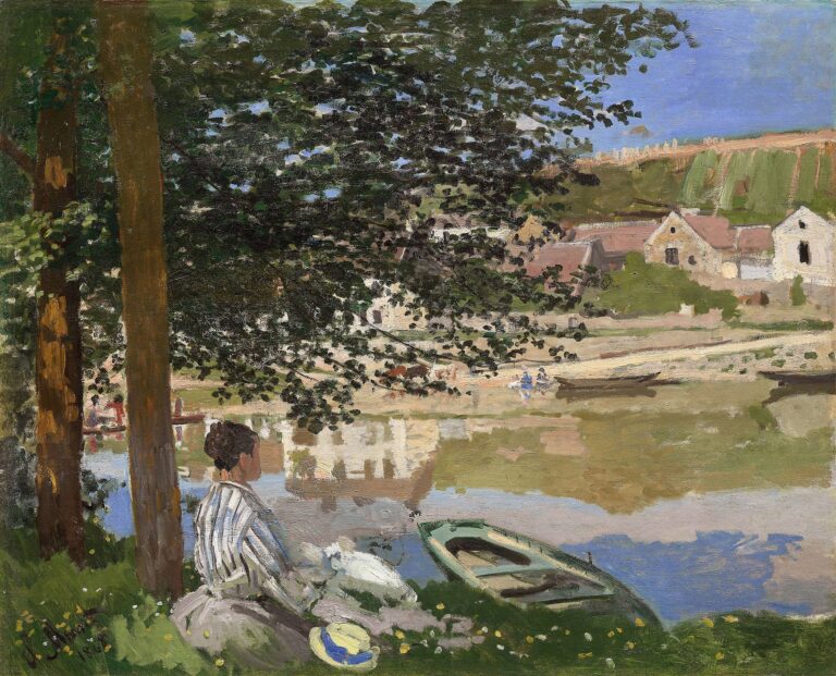 A woman seated beneath leafy trees on a grassy riverbank gazes across the Seine toward sunlit cottages and fields, with a small rowboat at the water’s edge and soft clouds overhead.