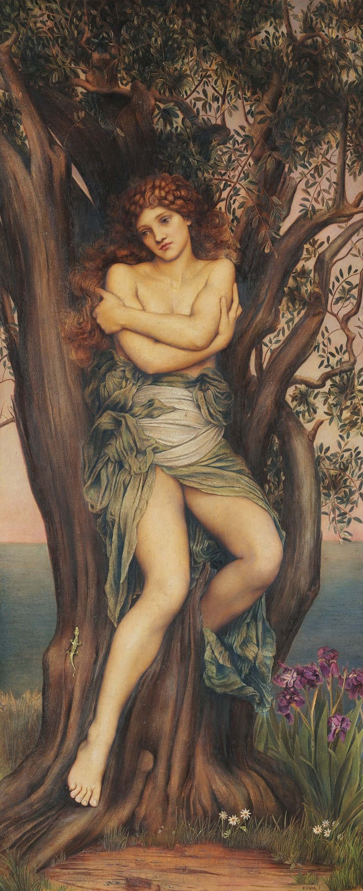 A mythic female figure with curly auburn hair and green drapery fused into the trunk of a large tree, her arms folded across her chest, surrounded by leafy branches, a small lizard, iris flowers, and a distant sea at sunset.