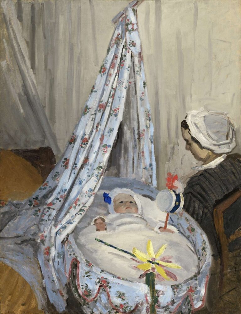 A woman dressed in dark clothing and white cap sits beside a covered cradle draped with floral fabric; an infant lies inside, gazing upward at suspended toys under soft, diffused light.