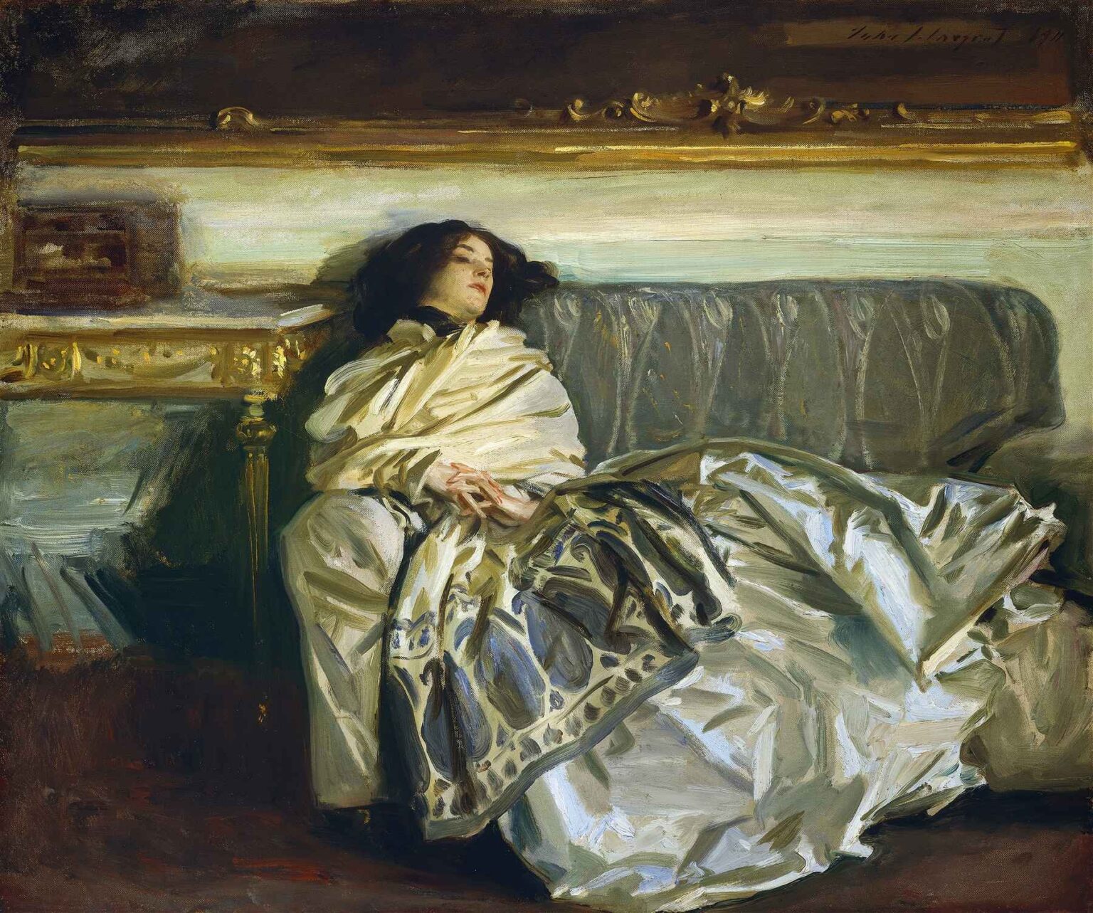 A woman in a voluminous ivory satin gown reclines on a green velvet sofa, her head tilted back in sleep, at rest in a warmly lit, elegantly furnished room.