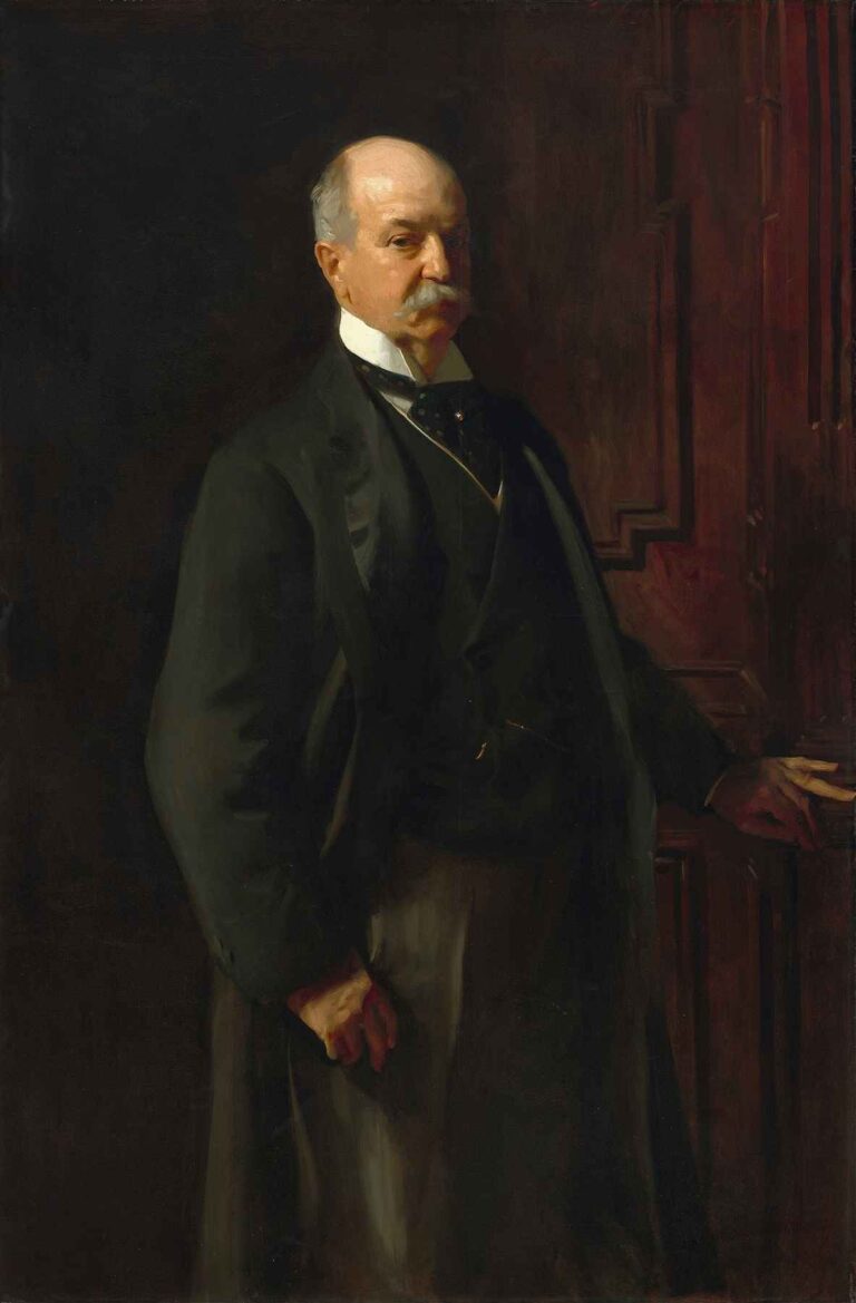 Full‐length portrait of industrialist Peter A. B. Widener standing beside a carved mahogany console, wearing a dark morning coat, white collar, and watch chain, against a dark wood‐paneled background.