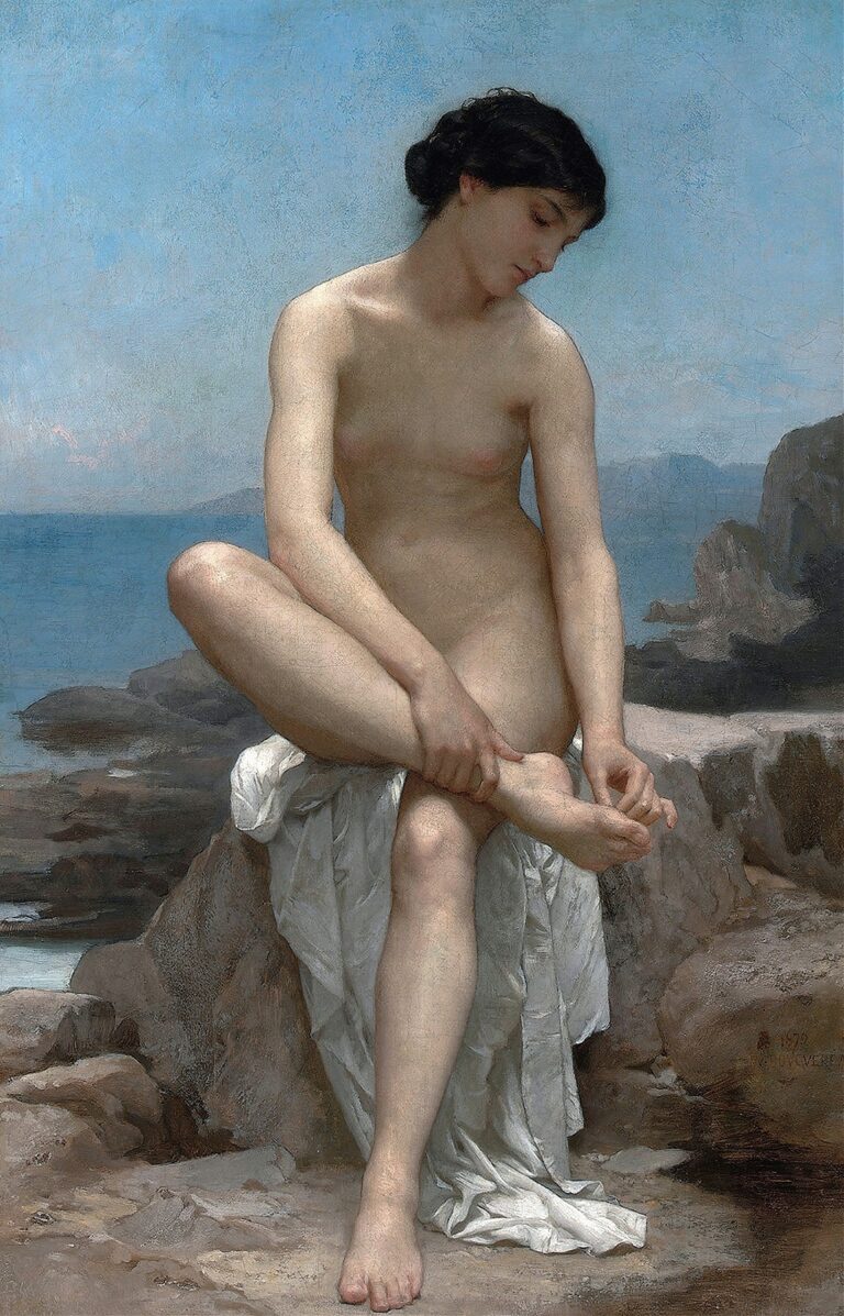 A nude young woman sits on a white draped rock at the water’s edge, one leg bent with her hands clasping her ankle, her head bowed thoughtfully against a pale blue sky and distant shoreline.