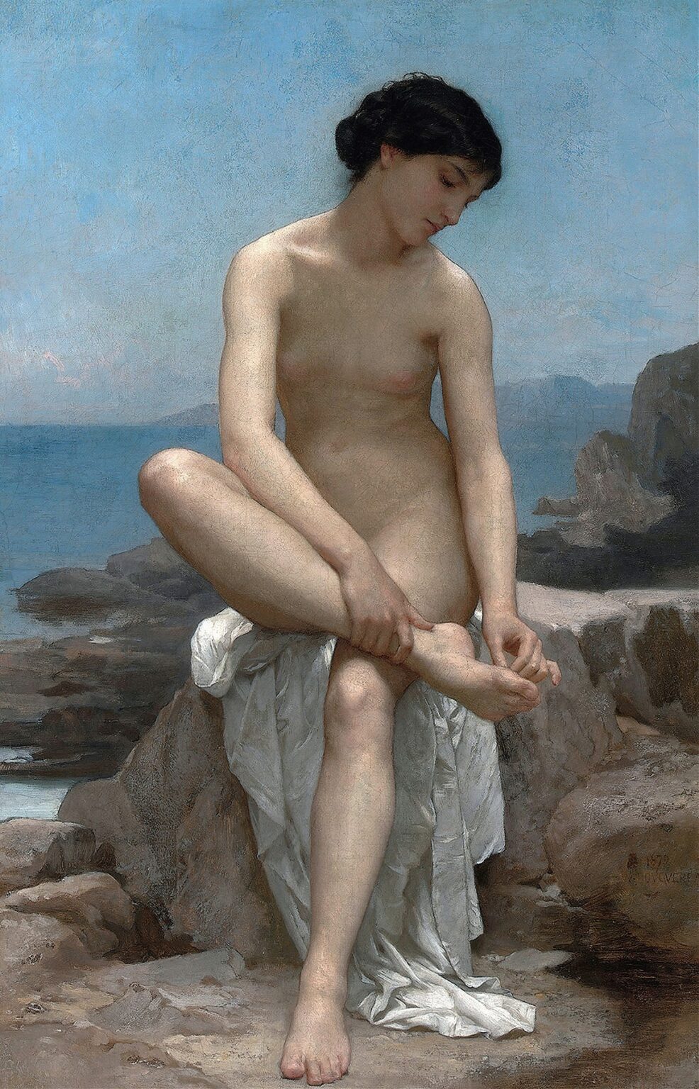 A nude young woman sits on a white draped rock at the water’s edge, one leg bent with her hands clasping her ankle, her head bowed thoughtfully against a pale blue sky and distant shoreline.