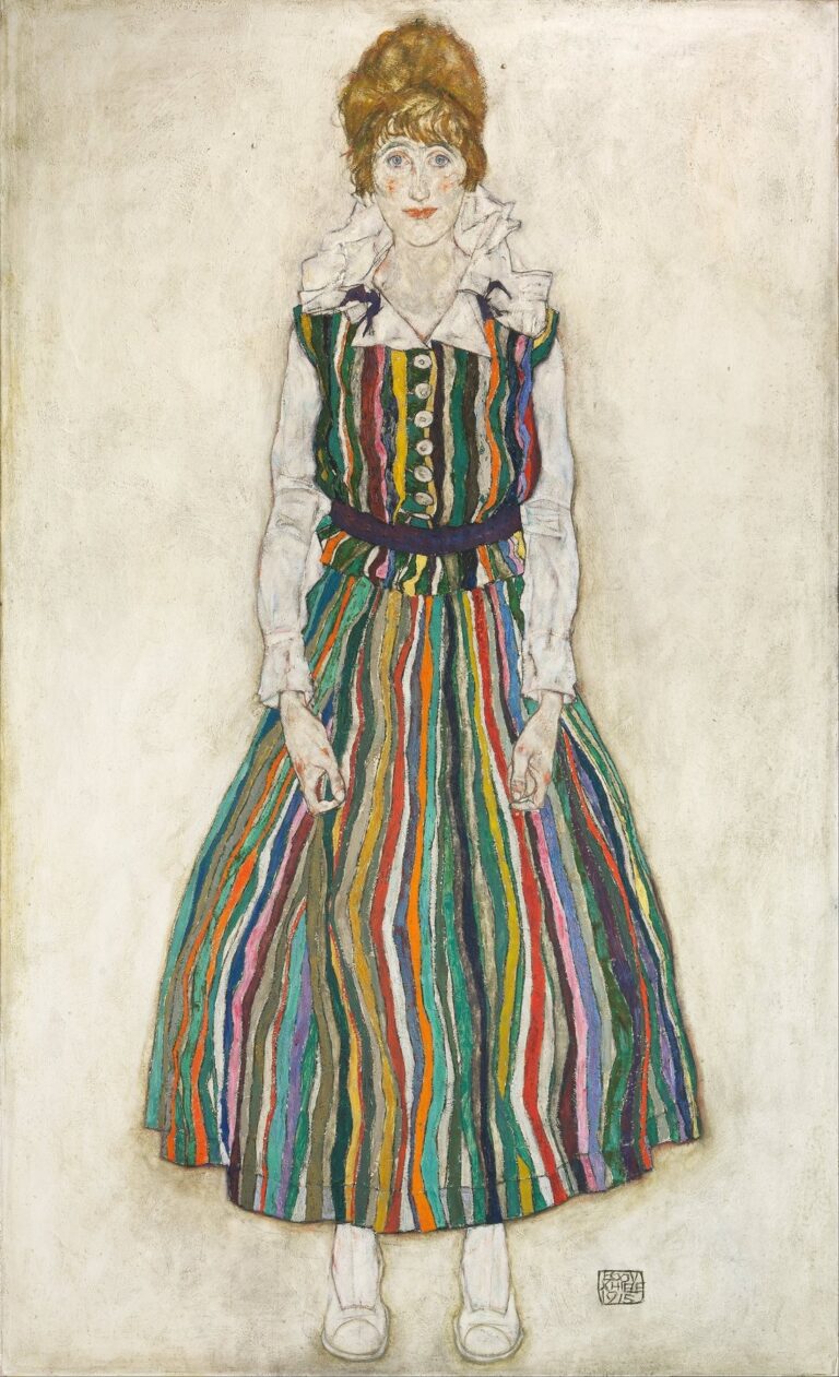 Full-length portrait of Edith Harms by Egon Schiele showing her standing against a pale background in a multicolored striped dress, white blouse, and white slippers, outlined in expressive black lines with an intense direct gaze.