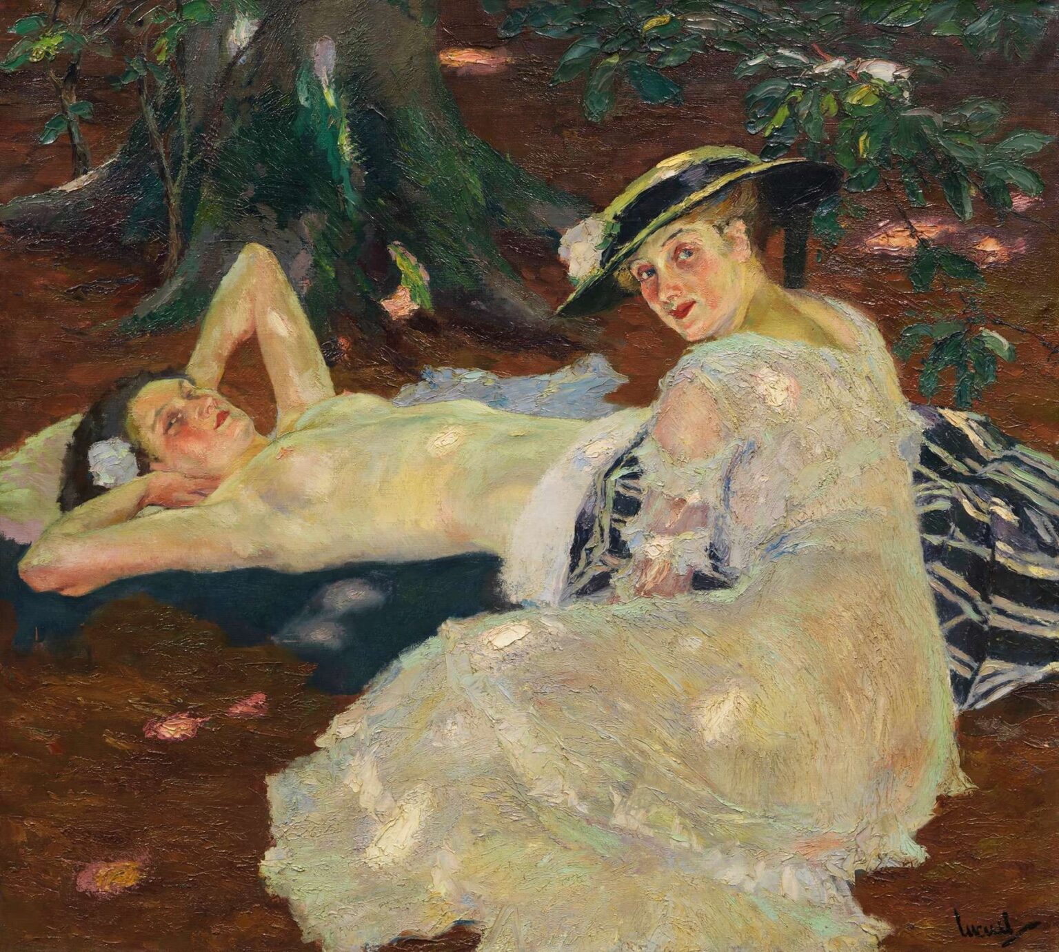 Impressionist oil painting of two women relaxing beneath a leafy tree—one reclining nude on a cushion, the other seated in a white lace jacket and straw hat—on a sunlit forest floor.