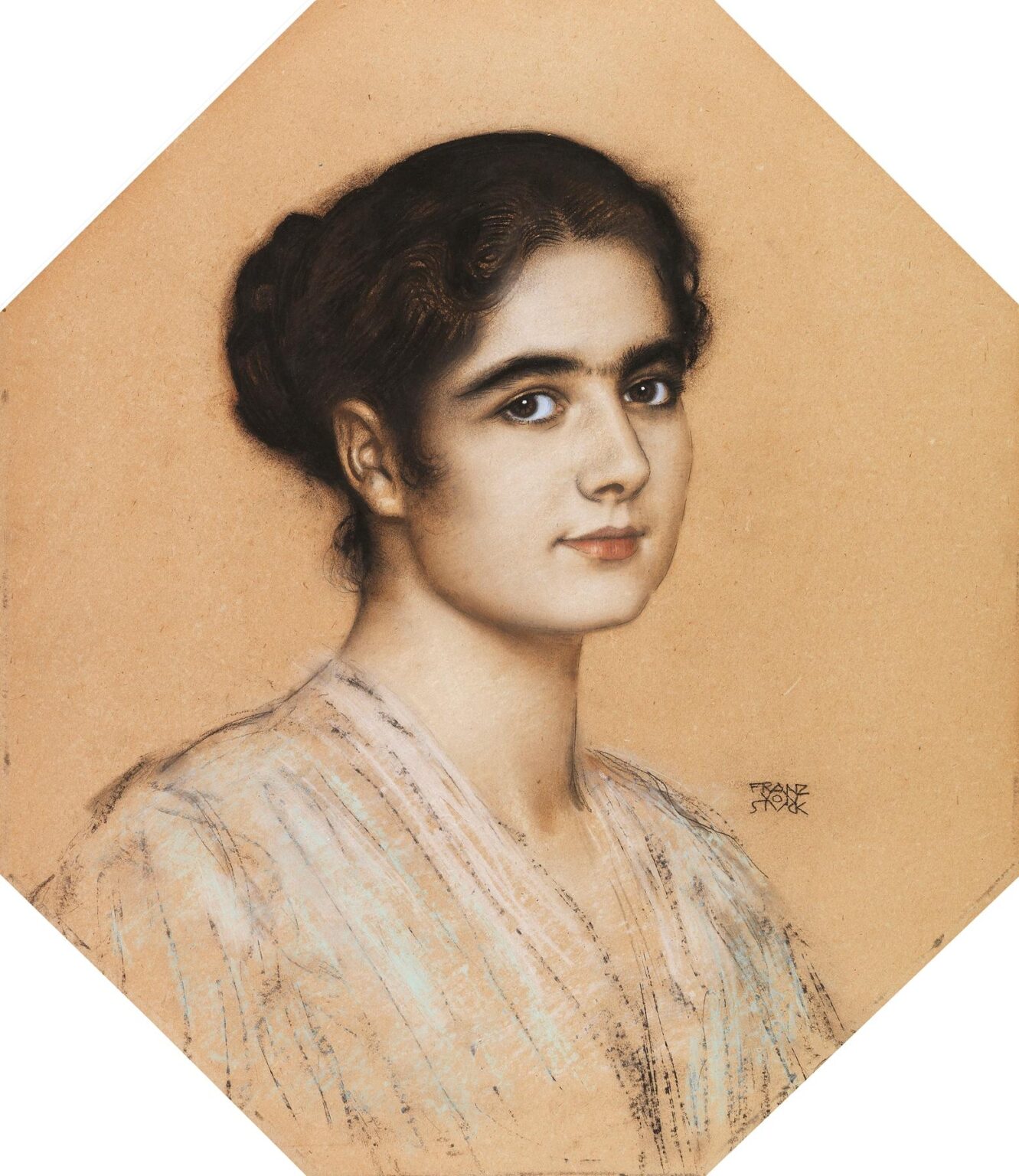 A softly lit portrait of a young woman with dark hair in a bun, gazing gently at the viewer with expressive eyes, set against a warm neutral background in Franz von Stuck’s Portrait of Daughter Mary (1912).