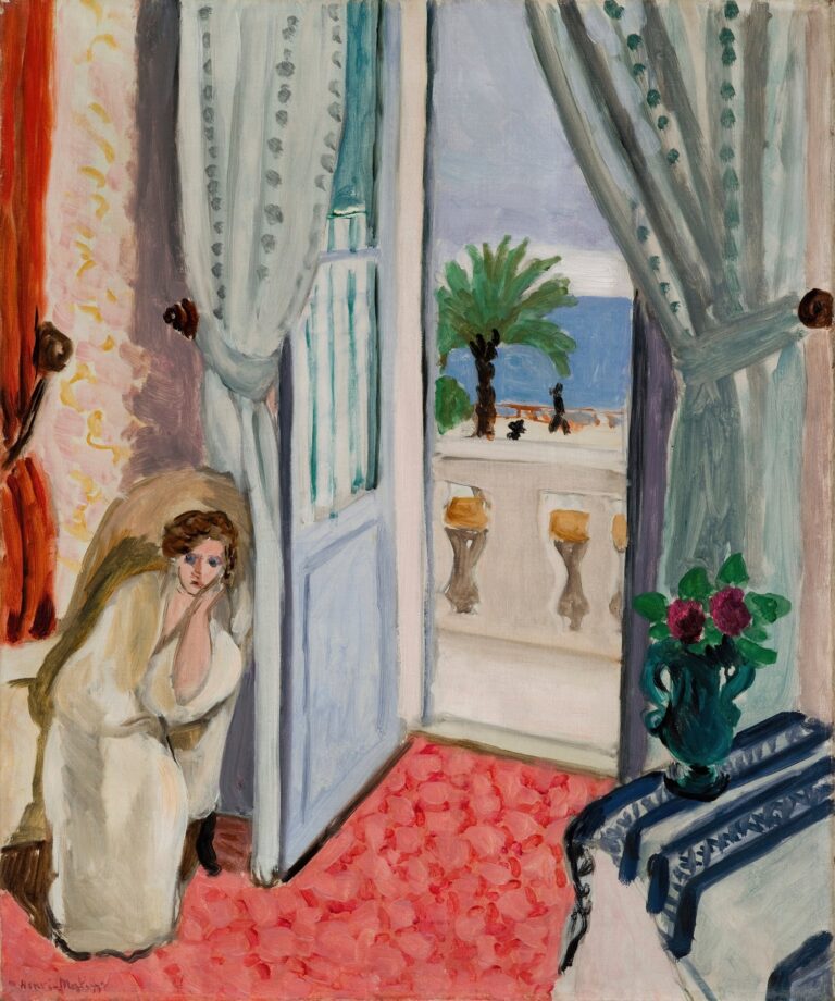 Matisse interior with a woman in a pale robe seated at left, an open blue door and sheer green-dotted curtains leading to a balcony with palm trees and blue sea, coral-pink tiled floor, orange drapery, and a dark green vase of red flowers on a striped blue table; painted with broad, airy strokes.