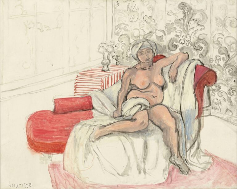 A nude woman wearing a light head wrap reclines across a red chaise longue, partly covered by a white sheet, in a bright interior. Gray floral wallpaper fills the right wall; at left, faint window lines and a small table with a red-and-white striped cloth hold a glass vase of flowers. Thin black contours, soft whites and grays, and accents of red create an airy, relaxed scene. Painted by Henri Matisse in 1920.
