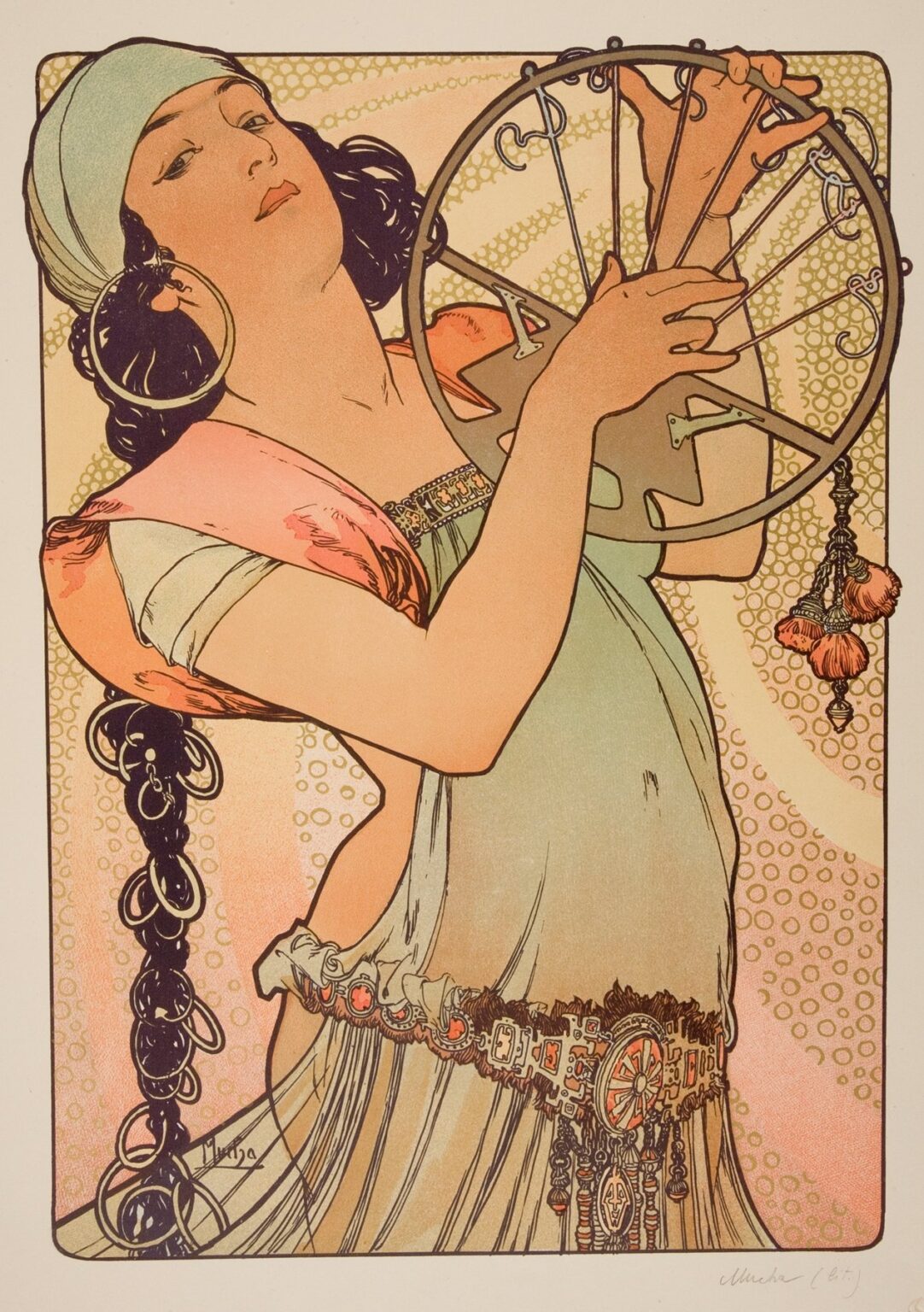 Art Nouveau lithograph by Alphonse Mucha of a dancer in a sea-green dress with coral scarf and headscarf, holding a circular tambourine-like hoop; large hoop earring, long looped braid, ornate belt, and a dotted swirling background suggest rhythm and motion.