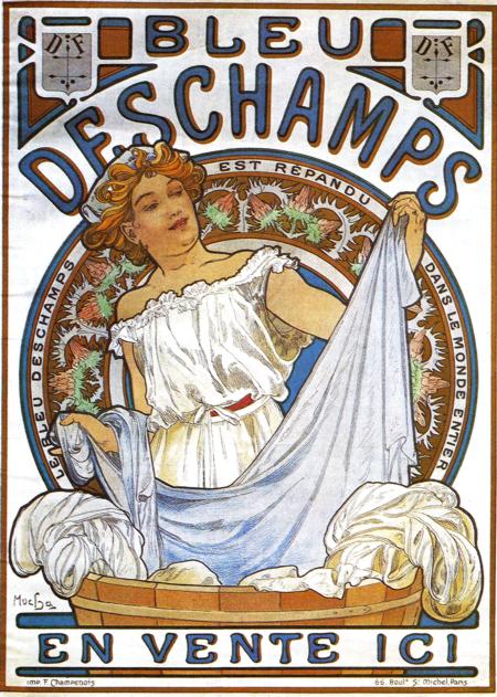 Art Nouveau poster showing a woman at a wooden washtub lifting a blue-white sheet. A circular floral medallion forms a halo behind her, and large curved lettering reads “Bleu Deschamps.” Cool blues and warm ochres dominate; the lower banner states “En vente ici.” Lithograph by Alphonse Mucha, 1897.