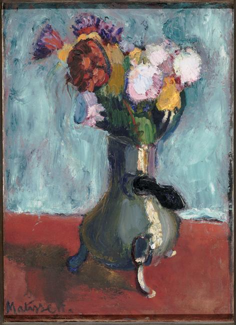 Centering a metal chocolate pot with a side handle used as a vase, a bright bouquet of pink, yellow, red, and violet flowers rises against a scumbled pale blue wall above a brick-red tabletop; thick, varied brushstrokes and chromatic darks emphasize color over detail.
