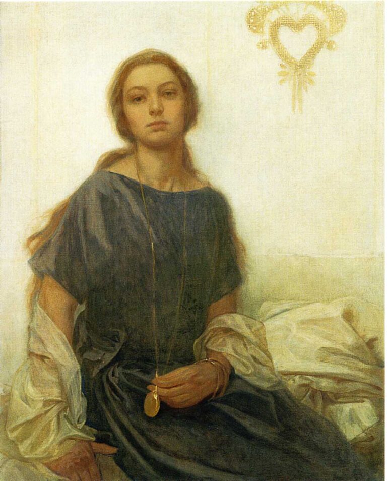 Seated portrait of a young woman with loose auburn hair wearing a blue-grey dress, holding a gold pendant on a long chain; a white drape rests at her elbow and a small gold heart ornament hangs on the pale wall behind her. The light is soft and even, creating a calm, intimate mood.