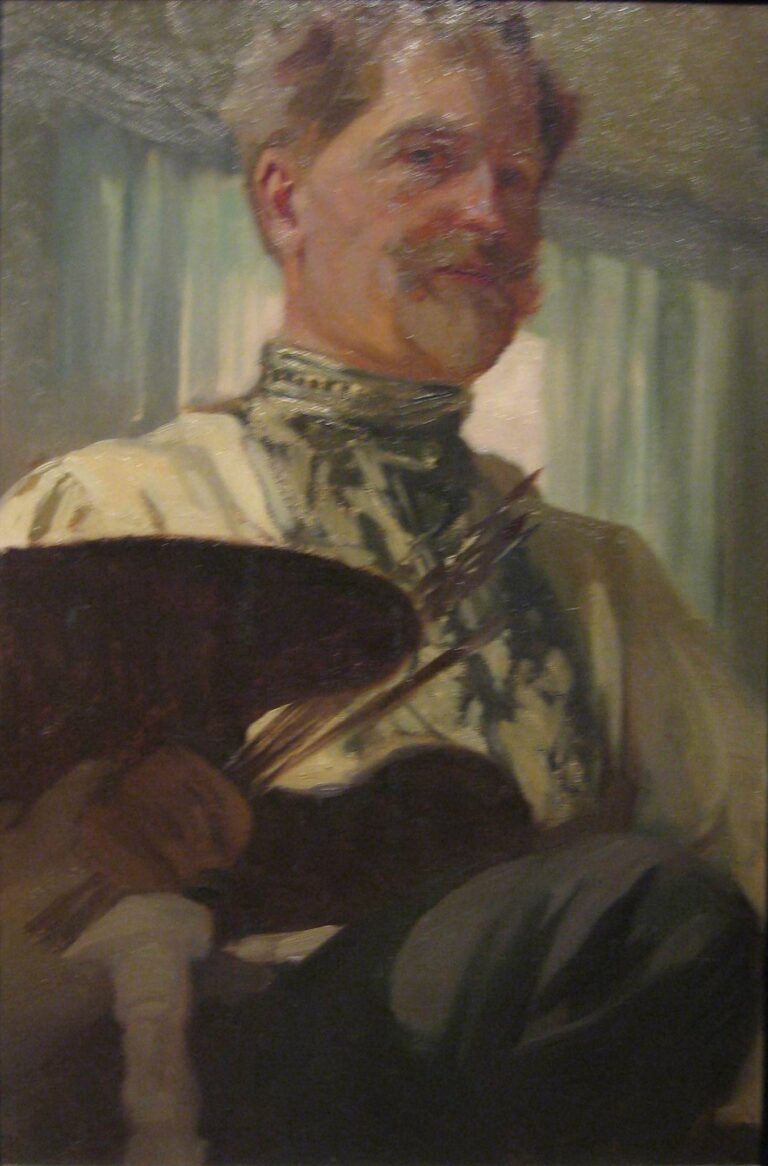 Alphonse Mucha’s 1907 self-portrait showing the artist in three-quarter view in his studio, wearing a light smock with a patterned collar, warm light on his face, a dark wooden palette and bundle of brushes in the foreground, and soft green curtains behind.