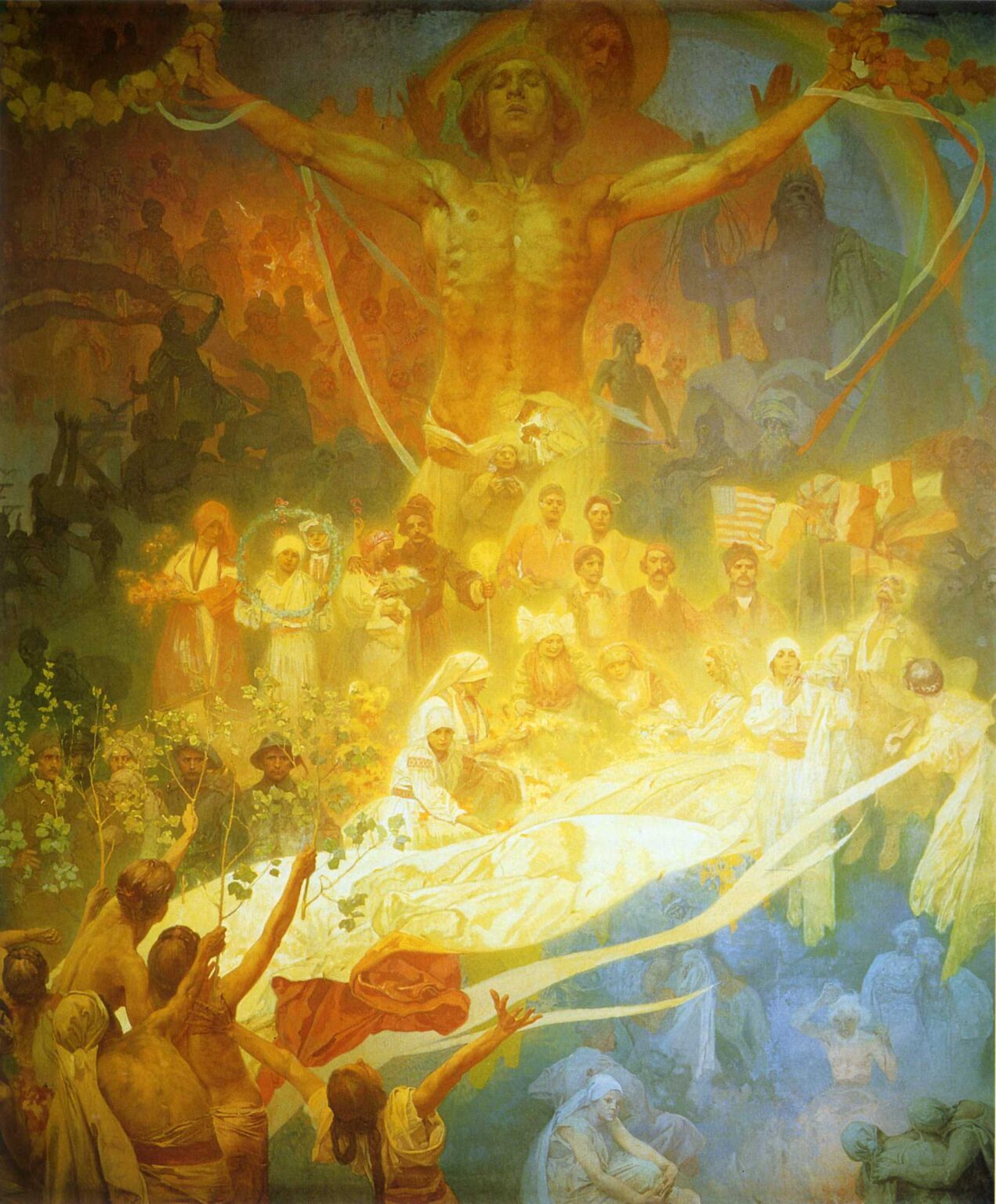 Monumental allegorical painting by Alphonse Mucha showing a golden, nude youth with outstretched arms above a crowded celebration; below, people of all ages in Slavic dress gather around a glowing white drapery as singers, dancers, and flag bearers join, while shadowy scenes of past struggle recede into the background and ribbons stream through warm yellow and cool blue zones.