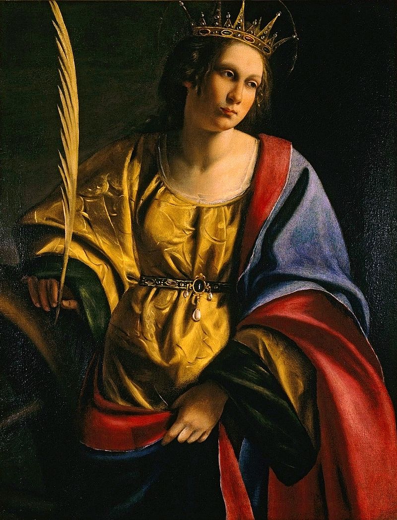 Crowned Saint Catherine stands in three-quarter view holding a palm frond, wearing a gold satin bodice with a blue and red mantle, her gaze thoughtful against a dark background with a faint suggestion of the torture wheel.