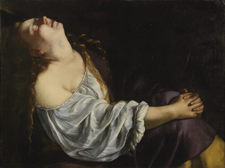 Close view of Mary Magdalene in profile, head thrown back and eyes closed, wearing a slipping white chemise and purple cloak against a dark background, hands clasped in prayer, illuminated by soft left-side light.
