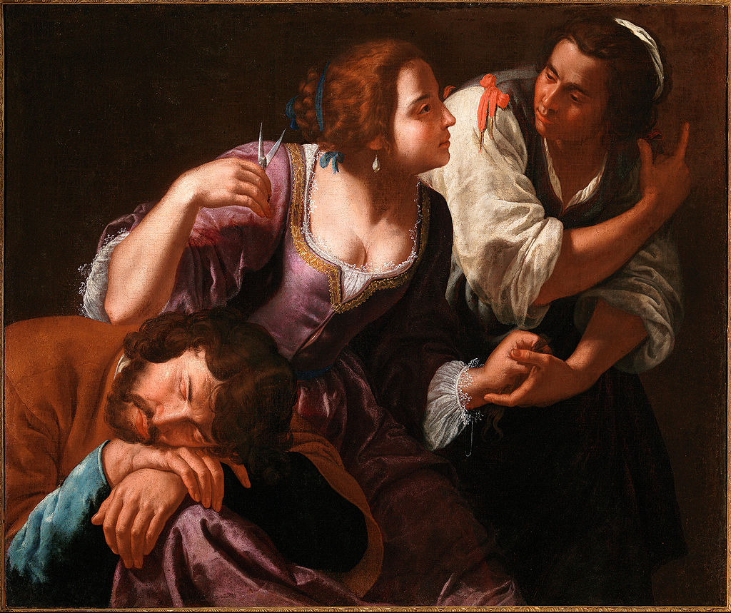 Close interior scene with Delilah in a violet dress cradling a sleeping Samson while raising scissors; an accomplice grips Samson’s wrist as the two women exchange a conspiratorial glance against a dark background.