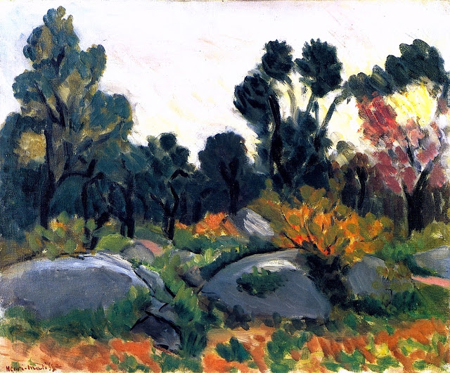 A sunlit Provençal hillside with gray boulders, green and orange shrubs, and silhouetted trees beneath a pale sky, painted with broad strokes and rhythmic outlines by Henri Matisse in 1925.