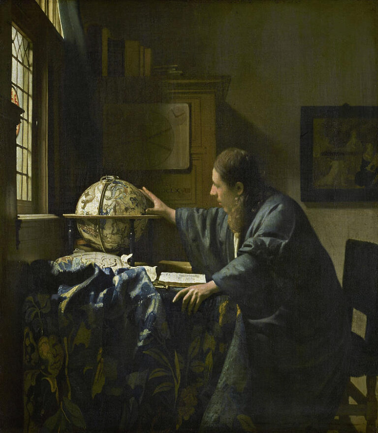 In a softly lit study, a man in a blue robe leans over a patterned table, one hand touching a celestial globe and the other on an open book; light from a leaded window illuminates his profile, the globe, and rumpled blue cloth, with charts and a framed picture on the wall.