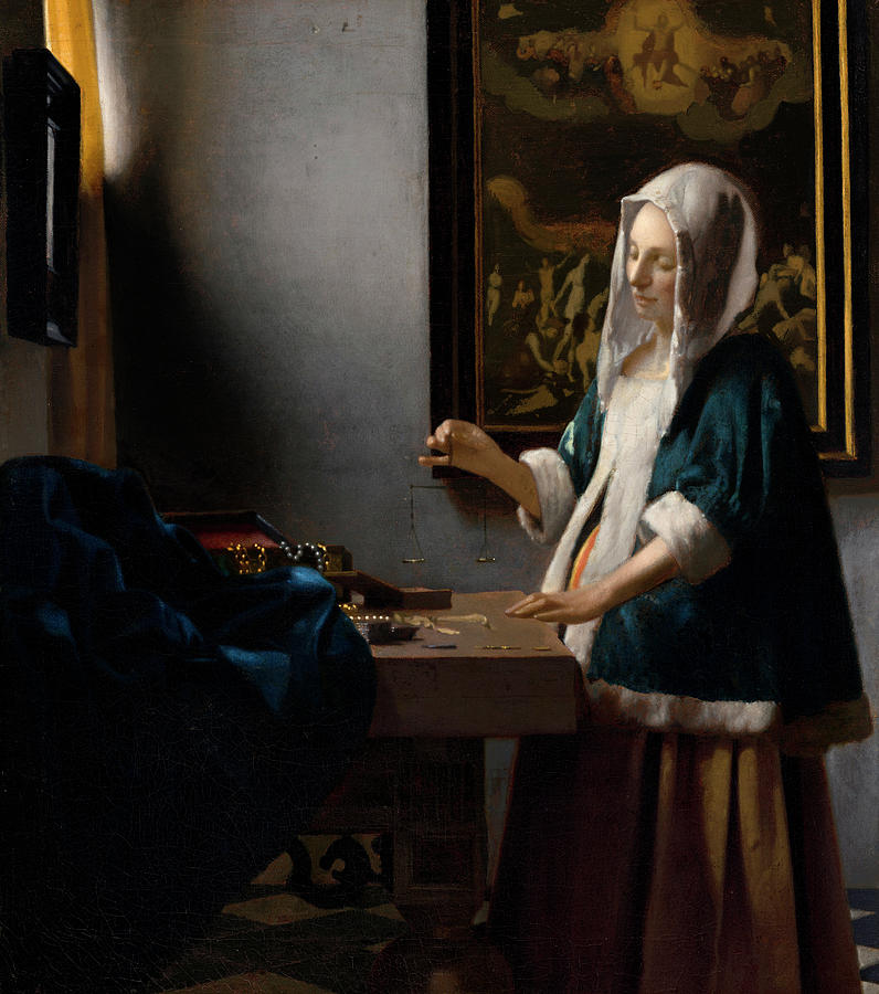 In a softly lit Delft room, a woman in a blue fur-trimmed jacket holds a tiny balance above a table scattered with jewelry and coins; a deep blue cloth, a small casket, and a large painting of the Last Judgment frame the scene.