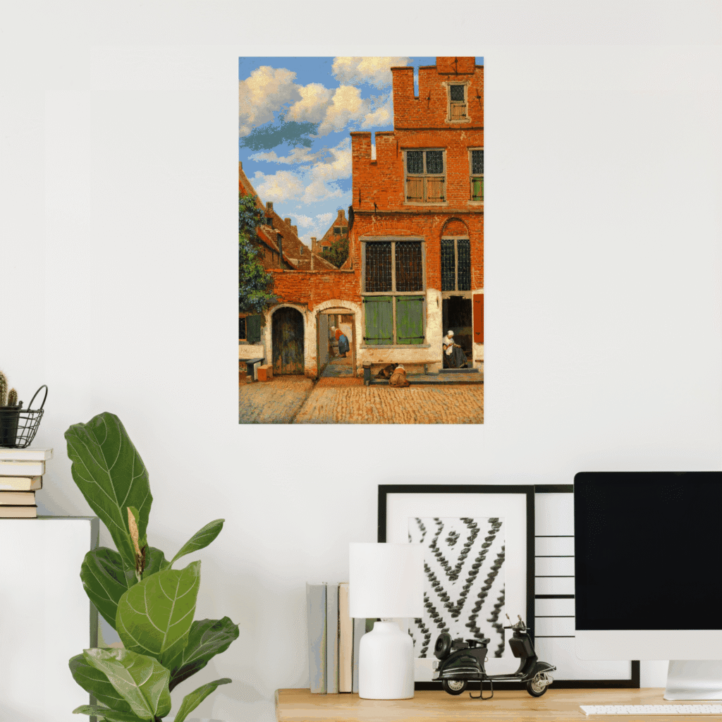 Poster of Johannes Vermeer’s The Little Street on a white wall in a modern home office, showing a Dutch brick house facade with green shutters, cobblestone street, and figures beneath a blue sky.