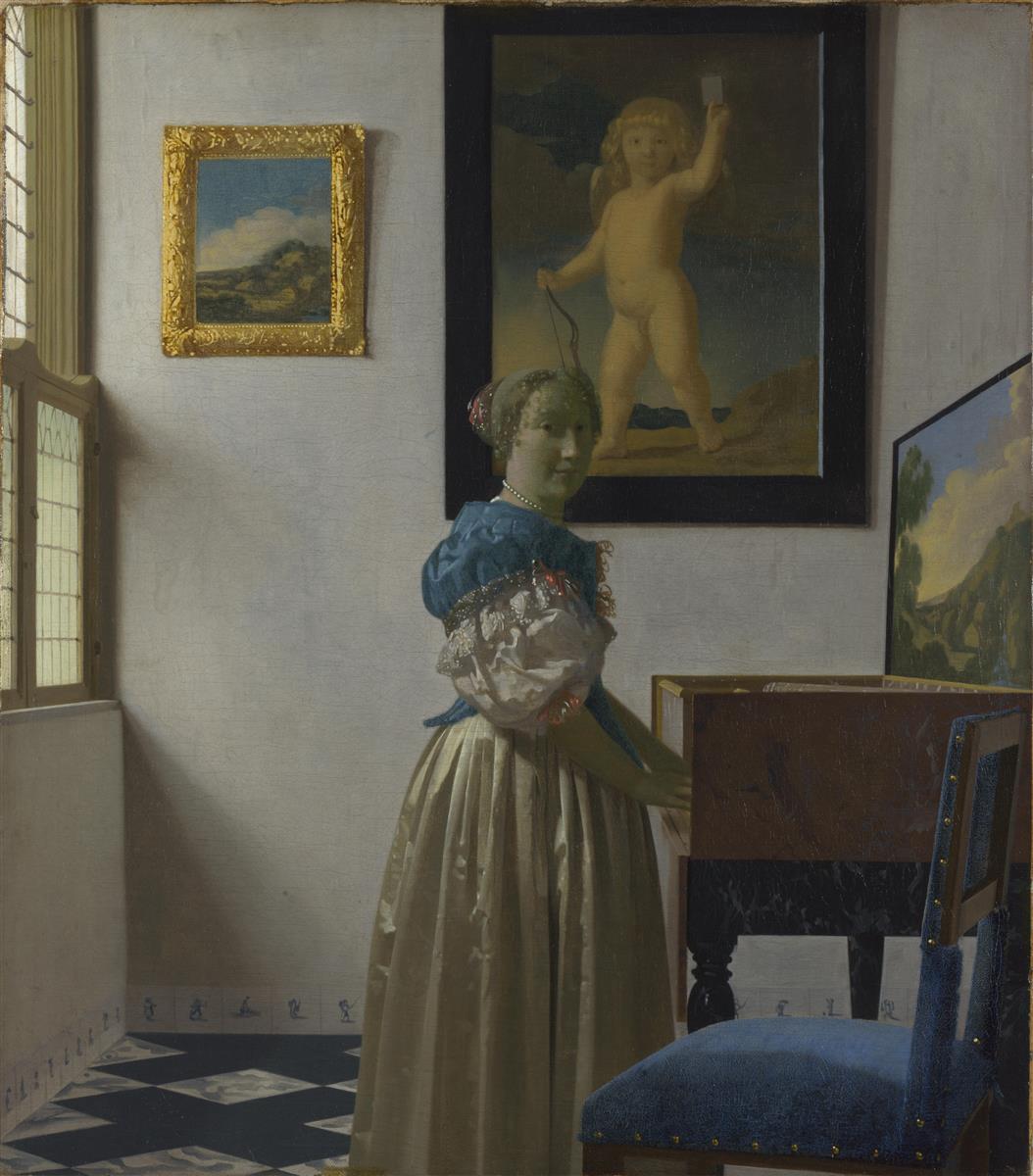 Sunlit room with a young woman standing at a virginal, looking toward the viewer; leaded-glass window at left, black-and-white tiled floor, a small framed landscape and a large painting of Cupid on the wall, and a blue upholstered chair in the foreground.