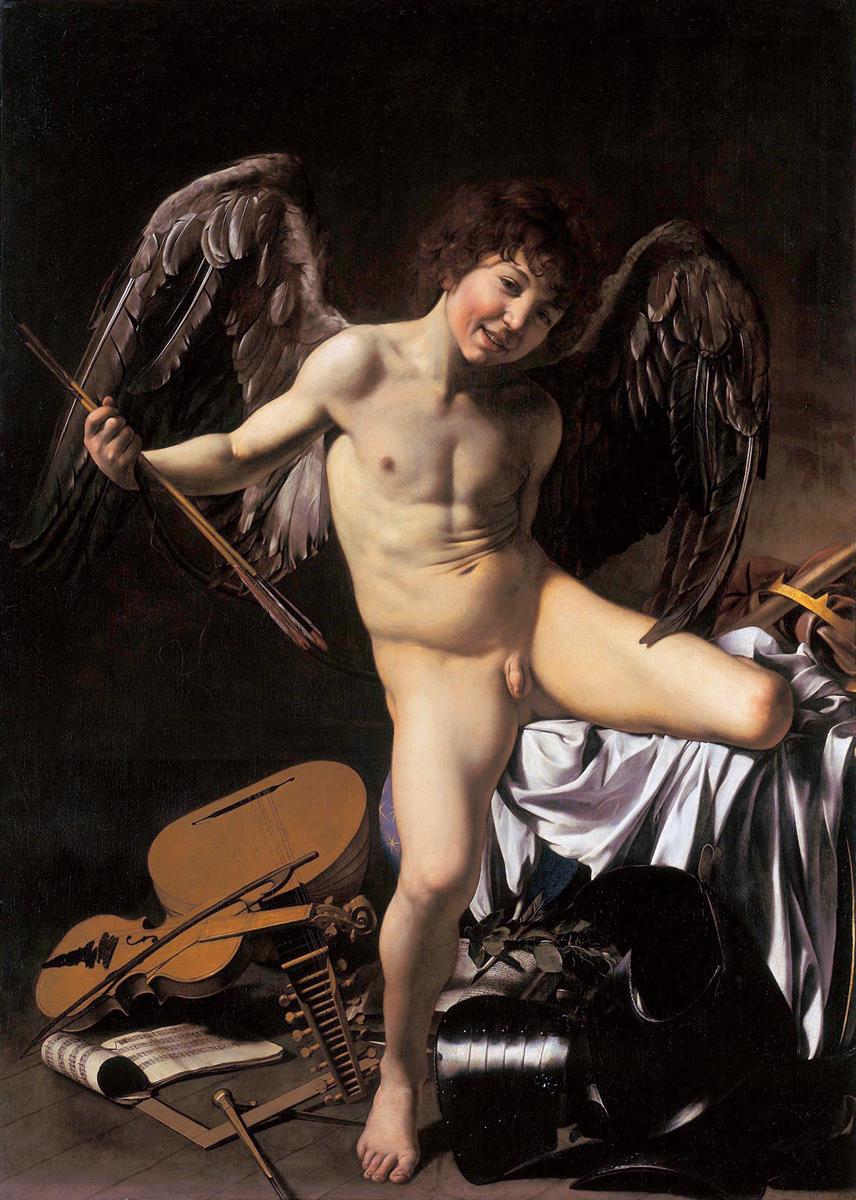 A nude, winged Cupid grins while standing on a rumpled bed, holding a bow as musical instruments, sheet music, a compass, and black armor lie scattered below; sharp light models his body and the satin drapery against a dark background.