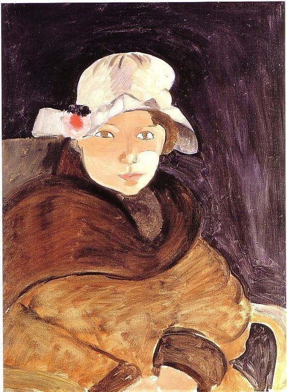 Half-length portrait by Henri Matisse (1918) of a young woman in a white hat with a small rosette, wrapped in a voluminous brown shawl against a dark violet-black background; simplified features, visible brushwork, and warm–cool contrasts emphasize her steady brown-eyed gaze.