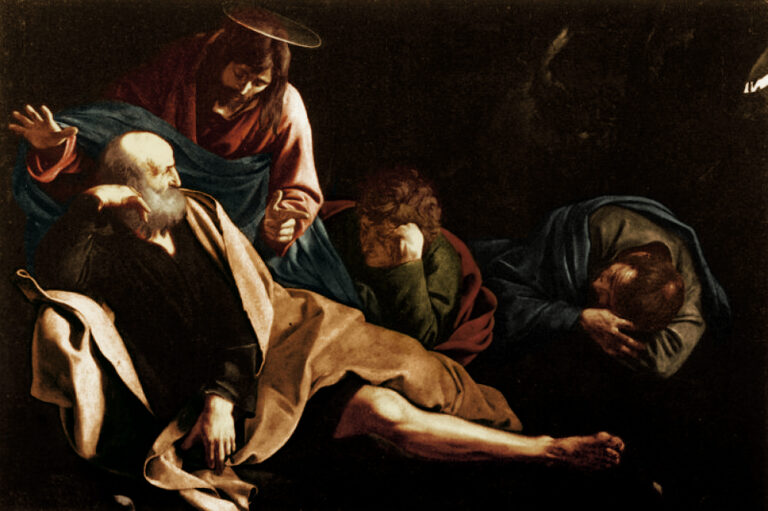 In a dark garden scene, Christ bends toward three sleeping apostles with one hand raised, his blue and red robes catching a soft beam of light while the disciples slump in earth-toned cloaks; the surrounding night is deep and empty, intensifying the intimate, hushed encounter.