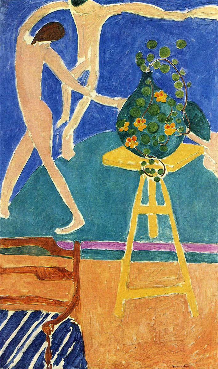 A bright studio interior by Henri Matisse showing a green vase of nasturtiums on a yellow trestle table and a wooden chair in the foreground, with a vivid blue wall behind that features the linked nude figures of “The Dance,” all rendered in flat, saturated color and bold contour.