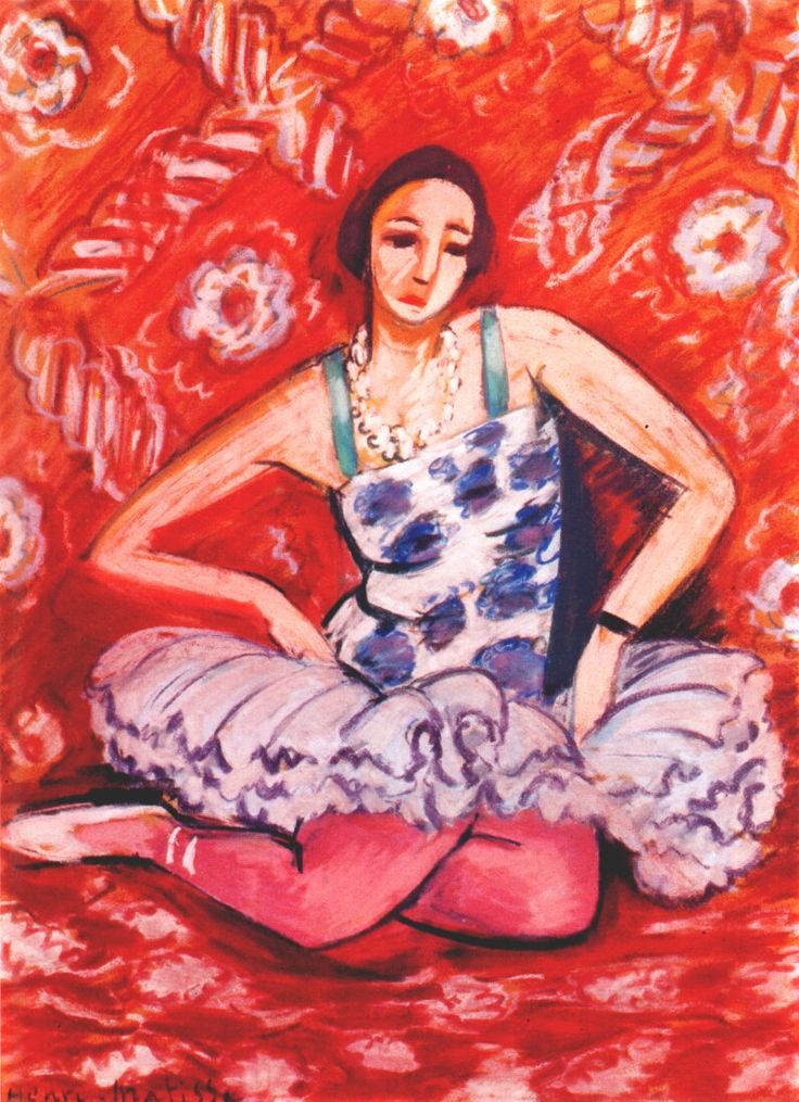 A seated dancer in a blue-spotted bodice, green straps, pink tights, and a lilac tutu poses against a vivid red patterned background, her arms adjusting the skirt and her head tilted in calm concentration, painted by Henri Matisse in 1925.