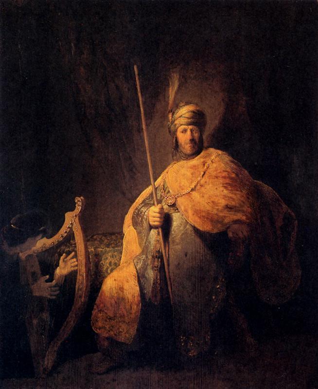 In a dark interior, King Saul sits monumental in gilded robes holding a tall staff while the young David, half-hidden at left, plays a harp; selective light glows on Saul’s mantle and David’s hands against a deep shadowed background.