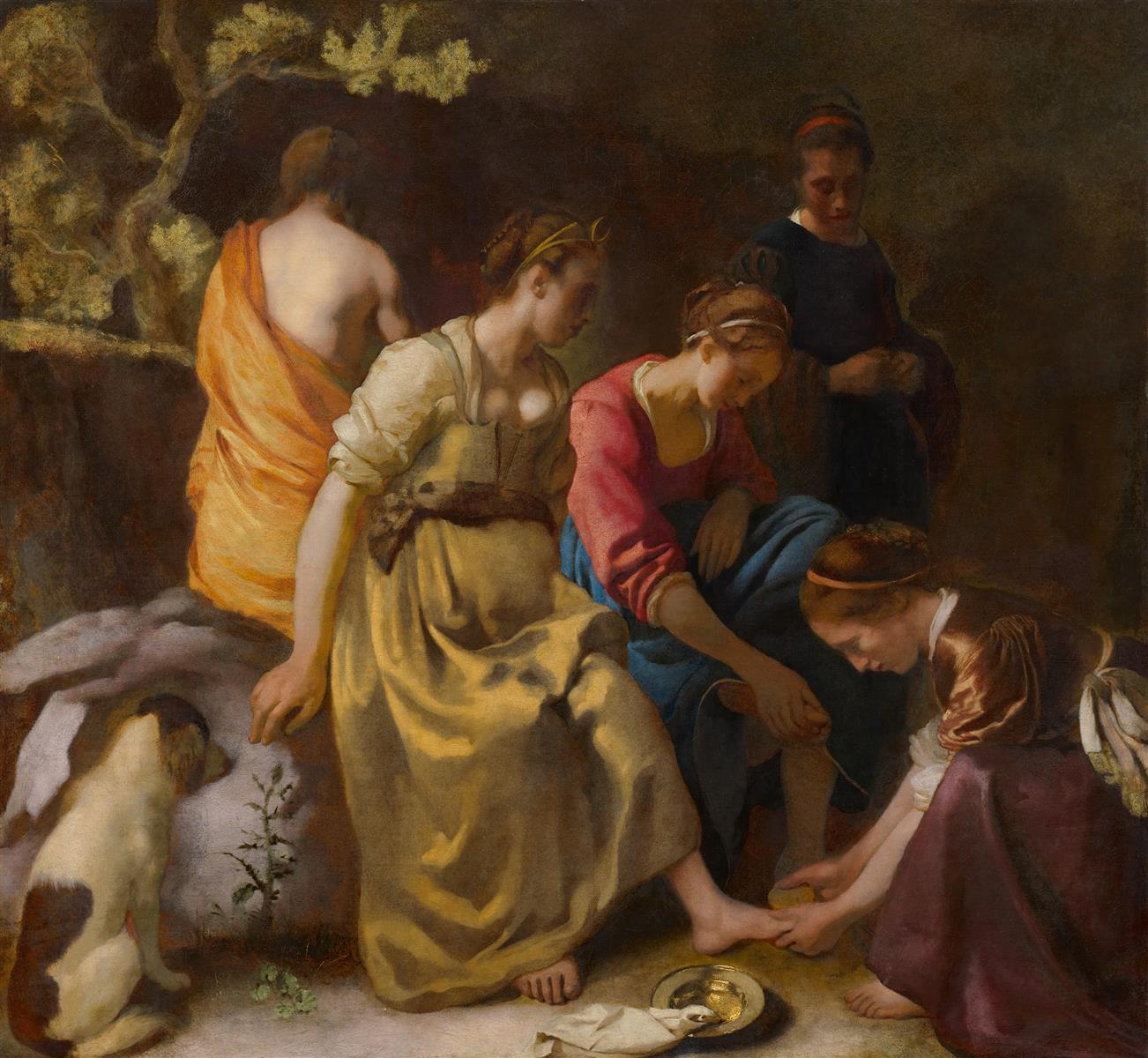 A quiet scene of the goddess Diana seated with nymphs in a shadowed rocky setting, one washing her bare foot over a small gilded basin, while others attend in muted ochres and deep blue, with a small dog watching at the left.