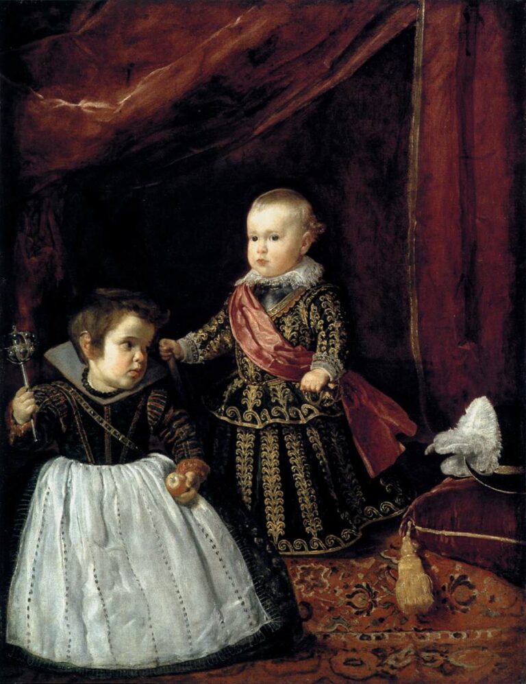 Two richly dressed children stand on a red carpet beneath heavy crimson drapery; the blond prince Don Baltasar Carlos faces forward with a sash and lace collar while a young court dwarf beside him holds a rattle and fruit near a cushioned stool with a plumed hat.
