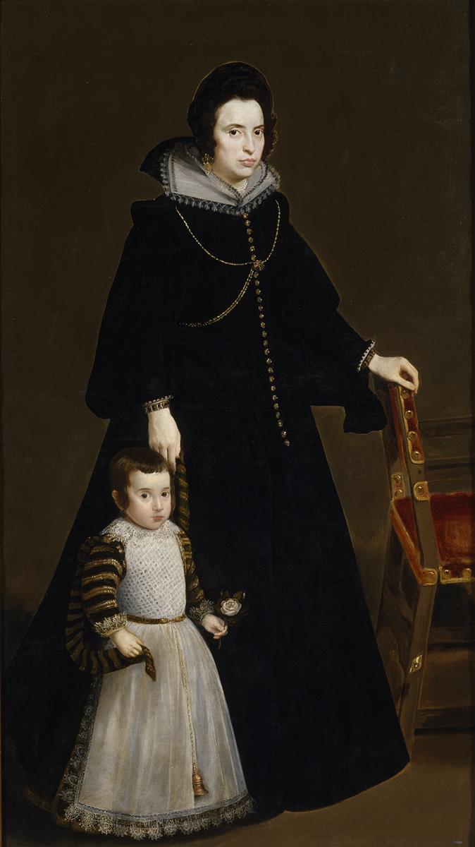 A noblewoman in a black velvet gown stands beside a gilt-studded red chair, resting one hand on the chair and the other on her young son’s head; the child, in white lace and striped sleeves, holds a small rose against a plain brown background.
