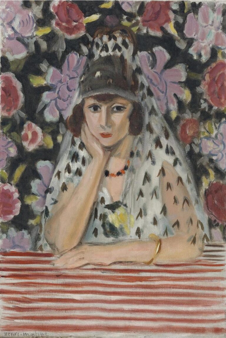 Bust-length portrait of a woman in a patterned mantilla and dark headpiece, resting her chin on her hand before a red-and-white striped table; behind her a dense floral tapestry of pink and crimson blooms fills the background, painted with expressive brushwork and clear, warm flesh tones.