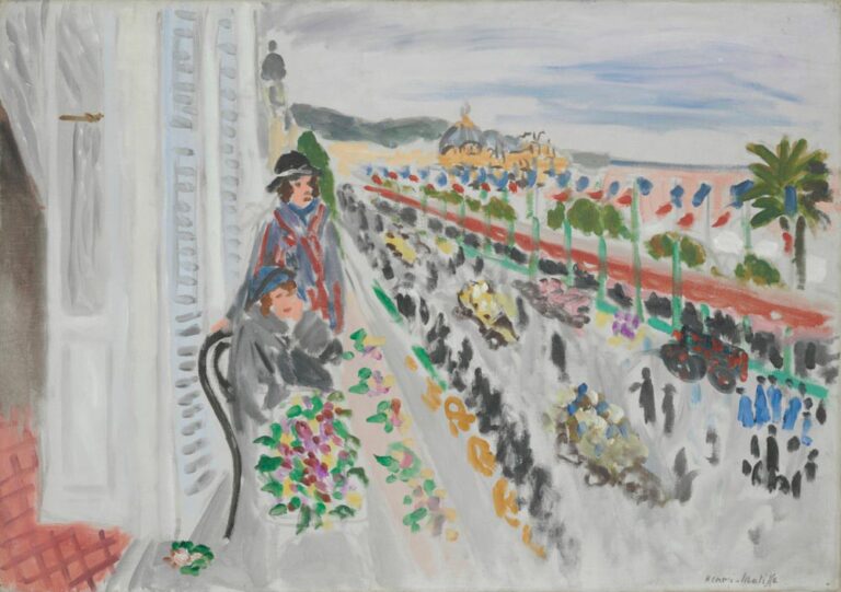 View from a white balcony over a parade along the Riviera: two figures lean at the railing above a gray street filled with moving crowds, cars, and flower-laden floats; a band of flags and palm trees lines the promenade; domed buildings and pale blue sky recede in the distance.