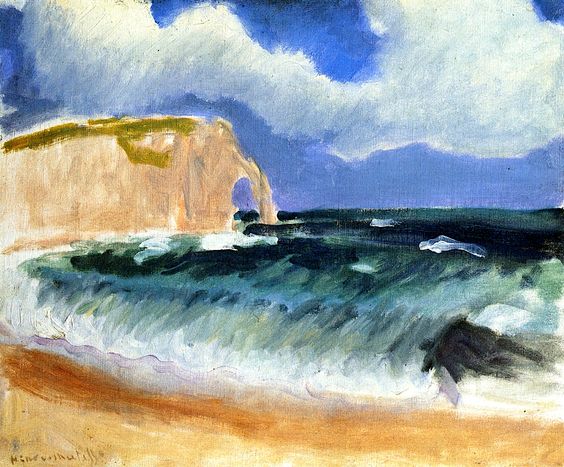 Windy Étretat shoreline with a pale chalk cliff and arch on the left, green-black waves breaking diagonally toward a sandy beach, and a sky of racing gray-white clouds with blue openings.