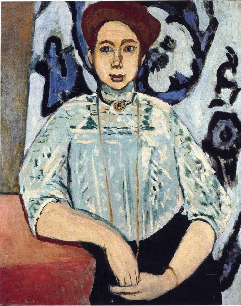 A seated young woman with reddish hair and a pale blue patterned blouse faces the viewer, hands folded at her lap, set against a bold blue-black decorative backdrop; simplified contours and balanced colors convey calm modern poise in Matisse’s 1908 portrait “Greta Moll.”