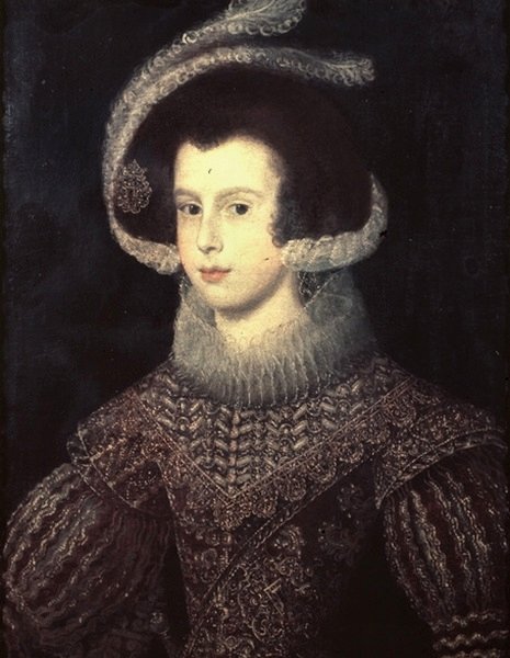 Three-quarter bust portrait of Isabella of Bourbon wearing a jeweled feathered headdress, high lace ruff, and richly embroidered black-and-gold bodice, her pale face softly lit against a dark background; painted by Diego Velazquez in 1625.