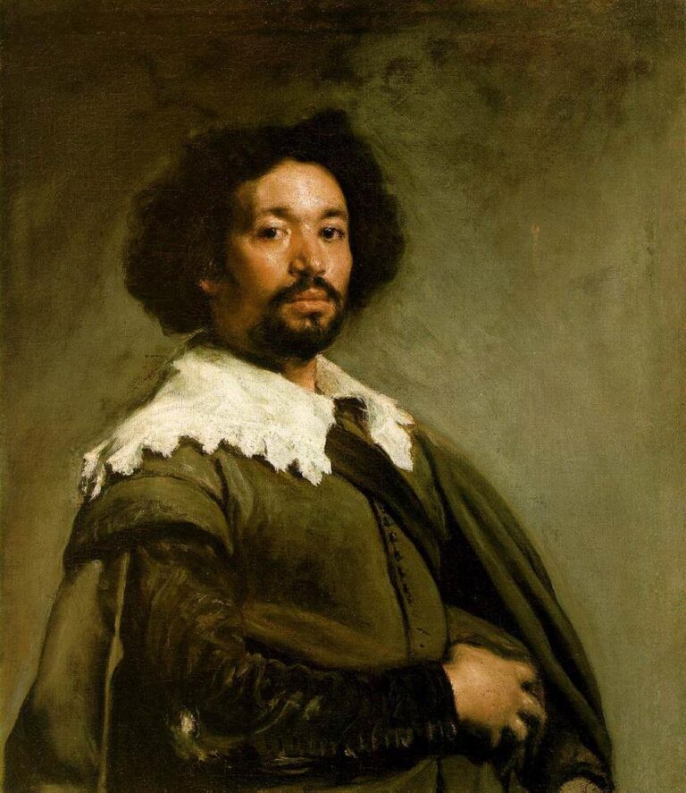 Half-length portrait of Juan de Pareja wearing an earthy green-brown doublet and draped cloak with a ragged white collar, turned three-quarters with a steady gaze against a soft gray-green atmospheric background.